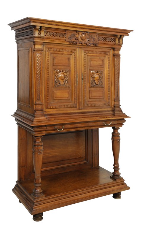 A LOUIS XVI STYLE WALNUT CREDENZA: A LOUIS XVI STYLE WALNUT CREDENZA Early 20th Century The rectilinear cornice highlighted by a carved cabochon with foliate details surmounts an intricately carved, recessed, conforming walnut body hou