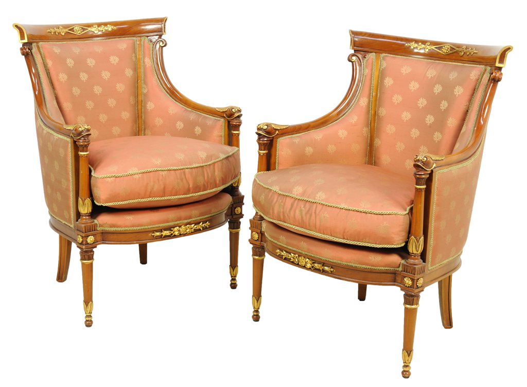 A PAIR OF EMPIRE STYLE PARCEL GILT CHERRY BERGERES 20th: A PAIR OF EMPIRE STYLE PARCEL GILT CHERRY BERGERES 20th Century Each chair features a curved, parcel gilt crest rail supported by a pair of exposed back supports and scrolling arms with carved dolphin