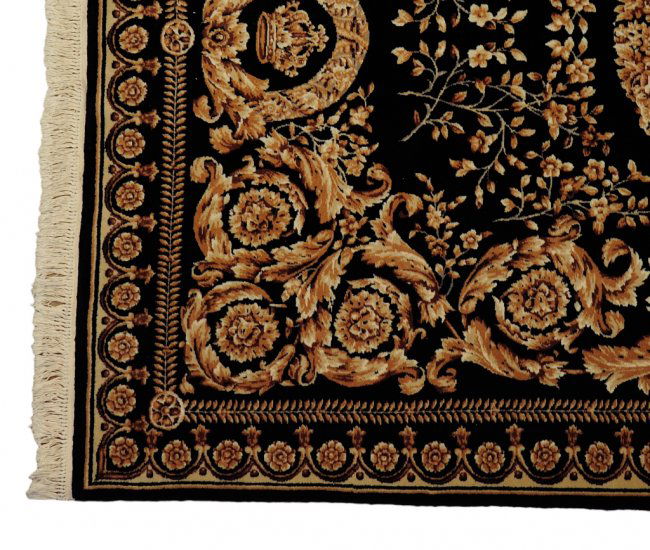 A HAND WOVEN BLACK AND GOLD VERSACE DESIGN RUG Lot 26