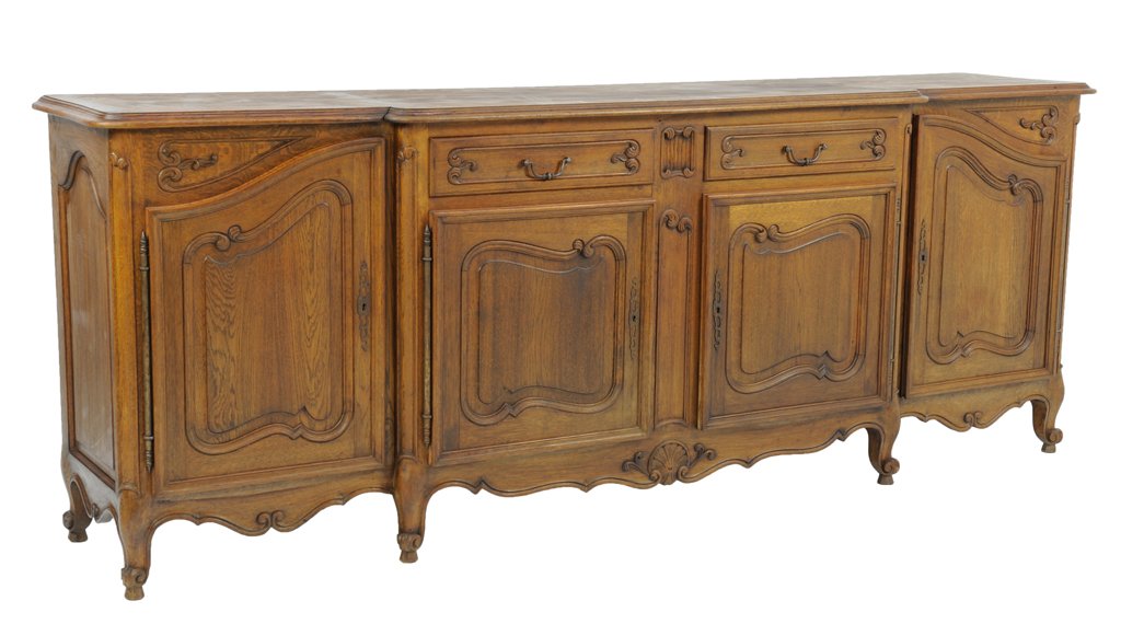 AN ANTIQUE LOUIS XV STYLE BUFFET ENFILADE: AN ANTIQUE LOUIS XV STYLE BUFFET ENFILADE Early 20th Century, France An antique Louis XV style enfilade with a bullnose edge, a stepped center with two drawers and two raised panel cabinets is flanked