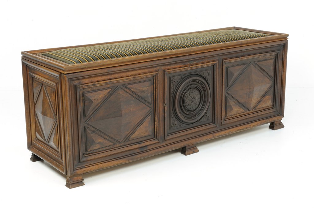 A LOUIS XIV STYLE STORAGE CHEST BENCH: A LOUIS XIV STYLE STORAGE CHEST BENCH 20th Century, France A Louis XIV style storage chest bench with padded, upholstered seat that flips open for storage in the interior, having raised panel carved d
