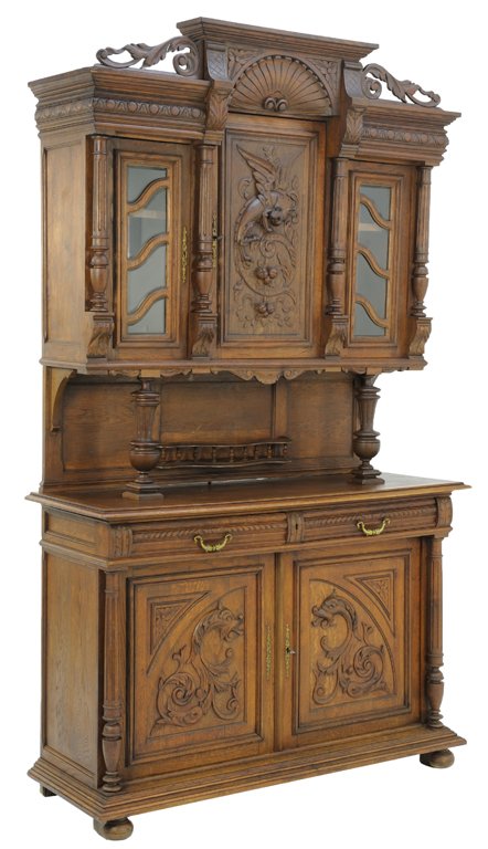 A HENRI II STYLE BUFFET WITH DRAGON: A HENRI II STYLE BUFFET WITH DRAGON Early 20th Century A Henri II style buffet with pierced foliate cornice, a carved shell frieze, a three panel upper is raised on vase turned uprights, and rests on 