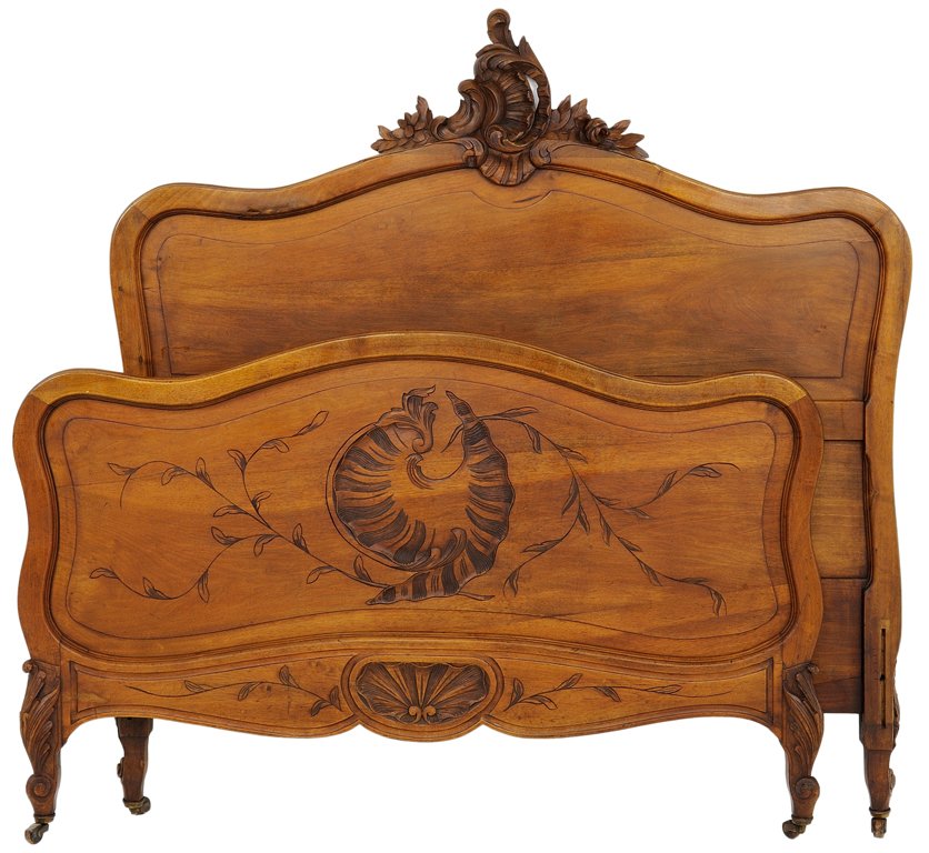 A LOUIS XV STYLE BED: A LOUIS XV STYLE BED Early 20th Century A Louis XV style bed in walnut finish with slightly arched crest rail with carved acanthus leaf motif and matching footboard with carved centered foliate and sh