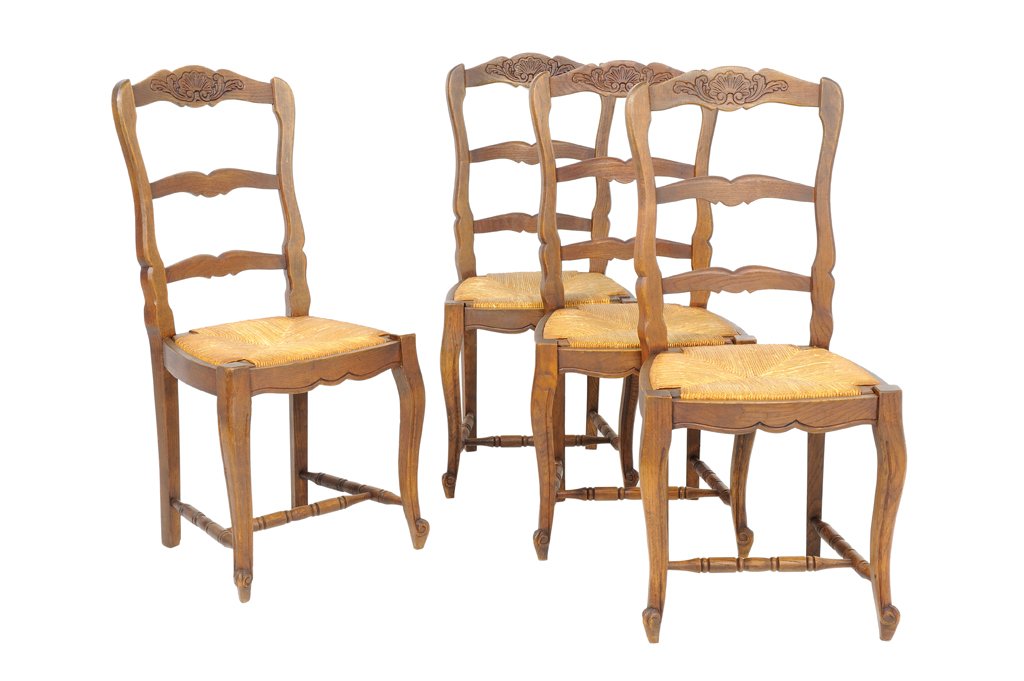 A SET OF FOUR FRENCH PROVENCIAL STYLE OAK SIDE CHAIRS: A SET OF FOUR FRENCH PROVENCIAL STYLE OAK SIDE CHAIRS Early 20th Century A set of four Louis XV style side chairs features carved shell with foliate shaped crest rail, a ladder back, woven rush seats,