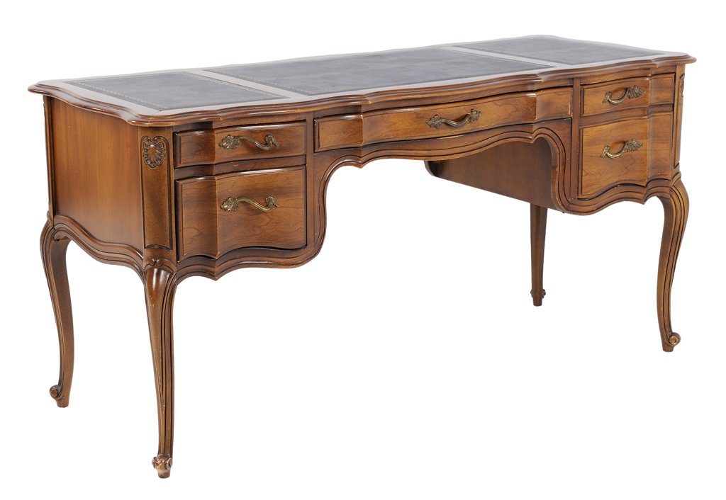 A LOUIS XV STYLE LEATHER TOP SERPENTINE OAK DESK: A LOUIS XV STYLE LEATHER TOP SERPENTINE OAK DESK Early-Mid 20th Century A Louis XV style desk with three part leather top, having a shaped bullnose edge, with a serpentine curve throughout coming to p