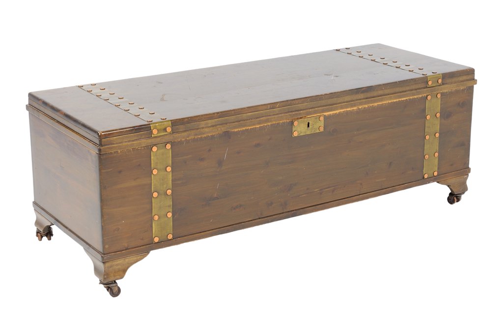 A CEDAR CHEST WITH BRASS AND COPPER HARDWARE: A CEDAR CHEST WITH BRASS AND COPPER HARDWARE Mid 20th Century A cedar chest with brass hardware with copper nail head rivets, is raised on bracket feet with casters. Wear detected. Overall in good con