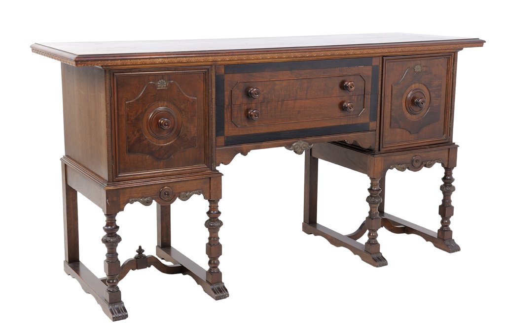 AN OAK ENGLISH STYLE SIDEBOARD BUFFET: AN OAK ENGLISH STYLE SIDEBOARD BUFFET Early-Mid 20th Century An English style sideboard features a carved dental edge, two cabinet doors with center having inlaid ebonized wood framed double drawer, f