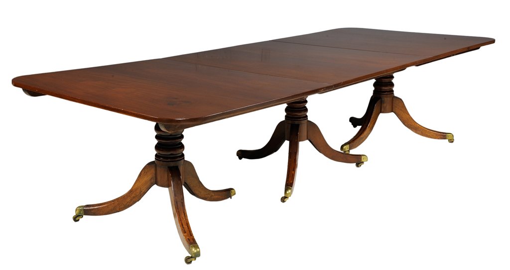 A LARGE SHERATON STYLE MAHOGANY DINING TABLE WITH TWO: A LARGE SHERATON STYLE MAHOGANY DINING TABLE WITH TWO LEAVES 19th Century The mahogany top is supported by three turned style pedestals on casters highlighted by fine inlay. Includes two leaves. Very 