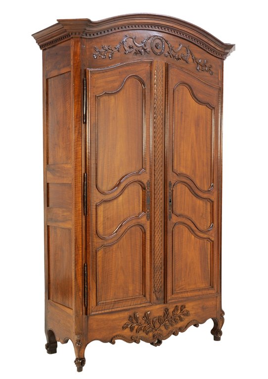 A LOUIS XV STYLE ARMOIRE IN WALNUT FINISH Early 20th: A LOUIS XV STYLE ARMOIRE IN WALNUT FINISH Early 20th Century The armoire features carved scrolling foliate at the cornice surmounting two locking doors highlighted by reserves and fish scale carving. 
