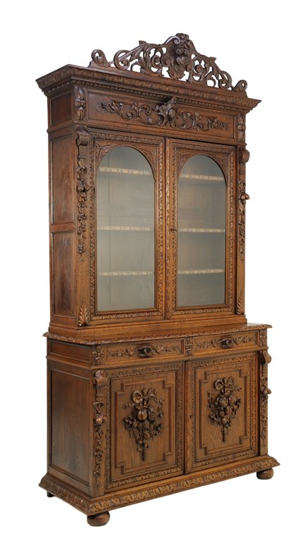 A VICTORIAN BAROQUE REVIVAL STYLE OAK BUFFET WITH: A VICTORIAN BAROQUE REVIVAL STYLE OAK BUFFET WITH FRUIT, RIBBON AND SHIELD Late 19th - Early 20th Century A Baroque Revival style buffet is crowned by a pierced carved scrolling acanthus cornice with 