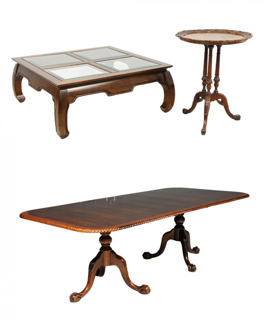 A FINE TABLE COLLECTION IN A MAHOGANY FINISH: A FINE TABLE COLLECTION IN A MAHOGANY FINISH 20th Century A ball and claw dining table having two cabriole triffid feet and twist edge is grouped with an asian tea table having a four part glass top,