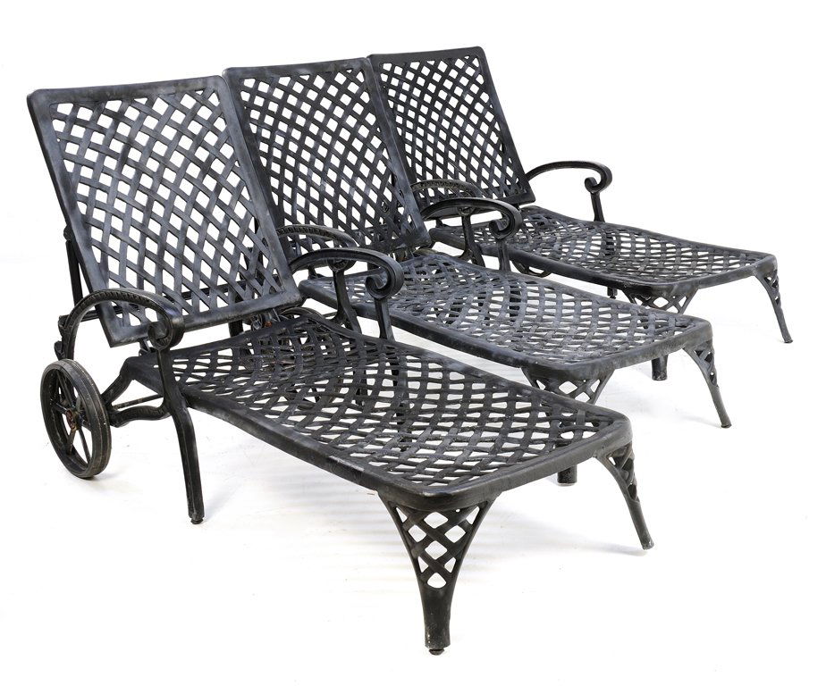 A COLLECTION OF THREE BLACK METAL PATIO RECLINERS: A COLLECTION OF THREE BLACK METAL PATIO RECLINERS 20th Century A collection of three black painted, metal patio recliners with lattice work support, and large wheels for easy placement in the sun. Min
