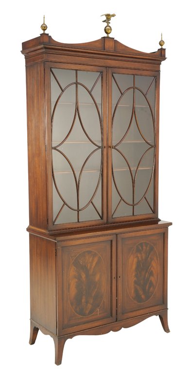 A FEDERAL STYLE FLAME ROSEWOOD BOOKCASE WITH EAGLE: A FEDERAL STYLE FLAME ROSEWOOD BOOKCASE WITH EAGLE 20th Century A Federal style bookcase features a Regency style cornice with central mounted eagle flanked by Federal period style finials, having a g