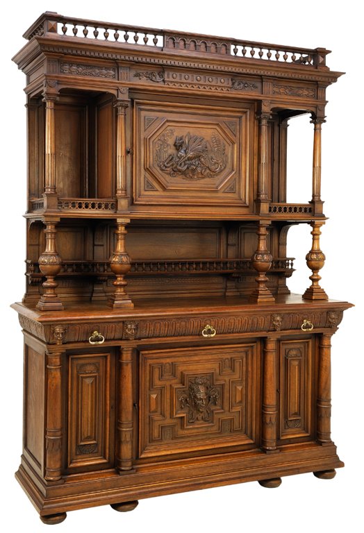 A HENRI II WALNUT BUFFET WITH CARVED DRAGON AND PAN: A HENRI II WALNUT BUFFET WITH CARVED DRAGON AND PAN FIGURE Early 20th Century A finial gallery crowns an intricately carved buffet featuring a carved dragon and pan figure in geometric reserves flanke