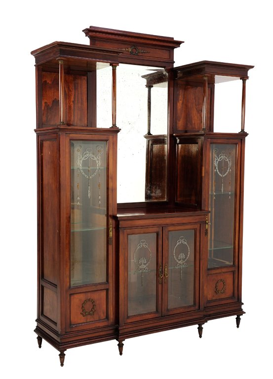 AN EMPIRE STYLE VANITY CABINET WITH WREATHS IN A: AN EMPIRE STYLE VANITY CABINET WITH WREATHS IN A MAHOGANY FINISH Late 19th - Early 20th Century A French Empire style vanity display cabinet features a carved wreath cornice, with double open upper sh