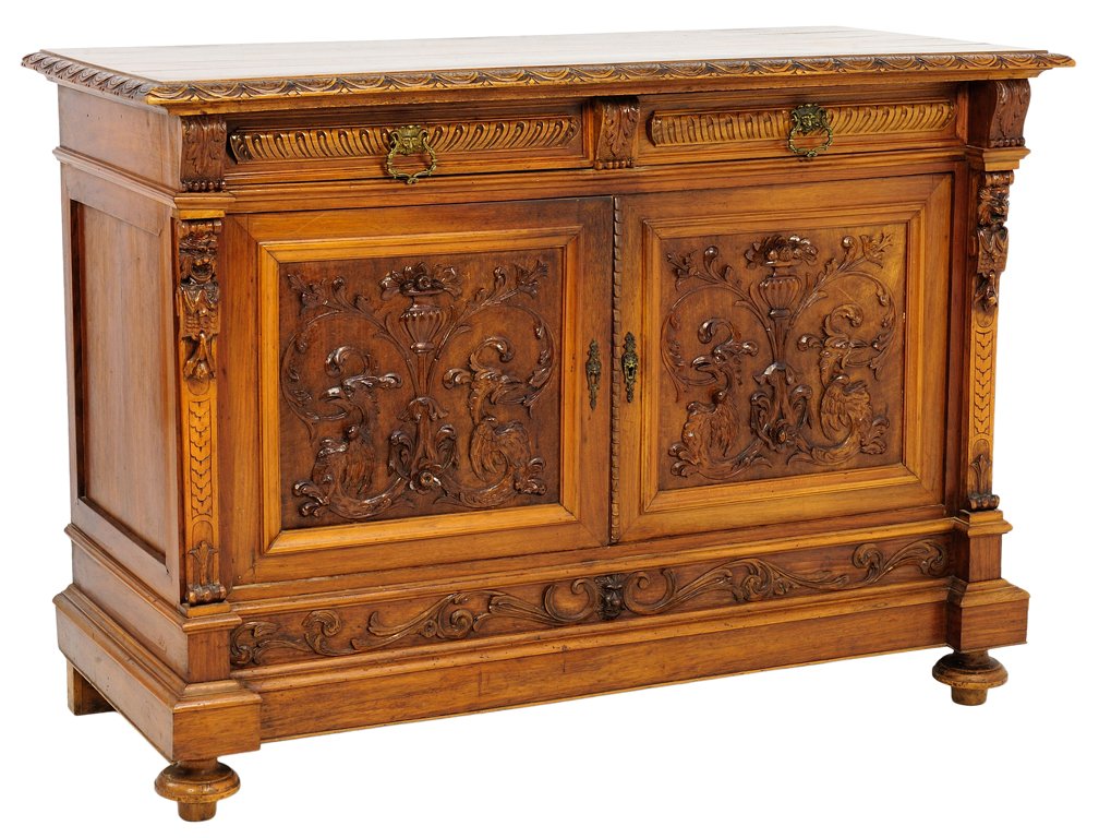A RENAISSANCE REVIVAL STYLE WALNUT SIDEBOARD WITH URNS: A RENAISSANCE REVIVAL STYLE WALNUT SIDEBOARD WITH URNS AND GARGOYLES Late 19th-Early 20th Century A Renaissance Revival style walnut sideboard with a carved demilune bullnose edge, having carved acant
