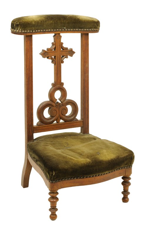 A CELTIC STYLE PRAYER CHAIR WITH TREFOIL: A CELTIC STYLE PRAYER CHAIR WITH TREFOIL 20th Century A prayer chair with olive green velvet fabric and nail head trim features a pierced carved cross with ""C"" scroll details that rests on a pierced