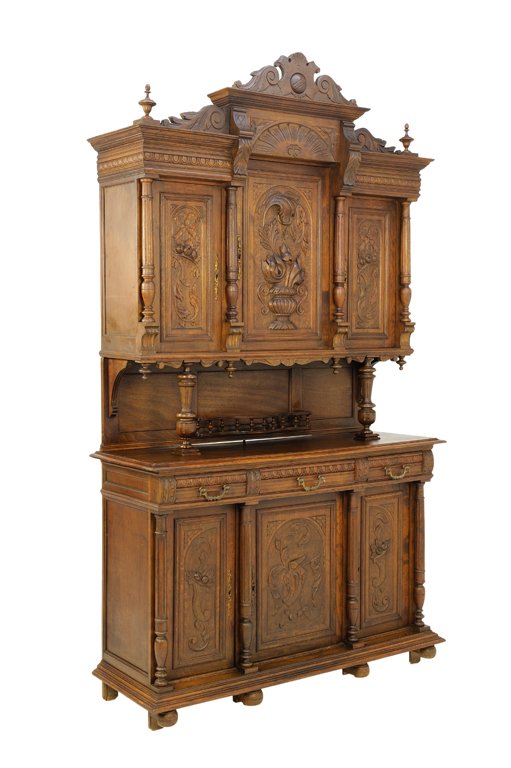 A VICTORIAN RENAISSANCE REVIVAL STYLE OAK BUFFET WITH: A VICTORIAN RENAISSANCE REVIVAL STYLE OAK BUFFET WITH CARVED FLAMING URN AND FRUIT Early-Mid 20th Century A Victorian Renaissance Revival style oak buffet features a swan neck pediment with scroll shi