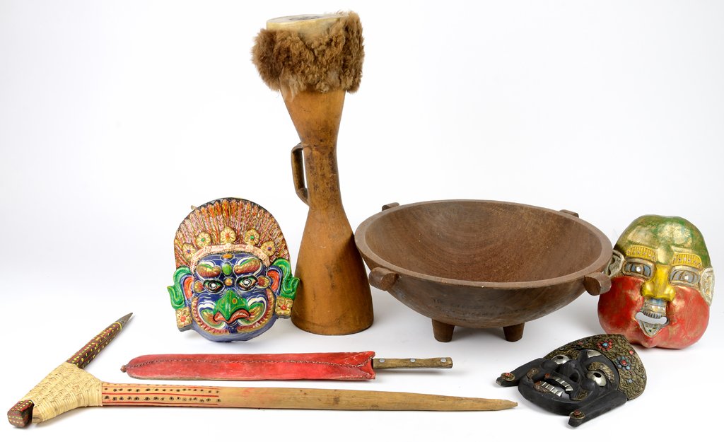 A PRIMITIVE COLLECTION OF DECORATIVE ITEMS FROM NEW: A PRIMITIVE COLLECTION OF DECORATIVE ITEMS FROM NEW GUINEA & JAMAICA Mid-Late 20th Century Includes drum, bowl, three maks, a weapon and tool. In very good condition. 7 x 20½ x 20½ inches