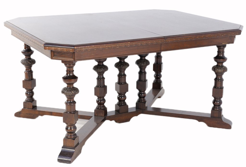 A VICTORIAN STYLE TURNED LEG TABLE WITH FLORETS: A VICTORIAN STYLE TURNED LEG TABLE WITH FLORETS 20th Century A Victorian style table features canted edges, with two drop leafs, having seven turned and carved with floret legs with block details, is