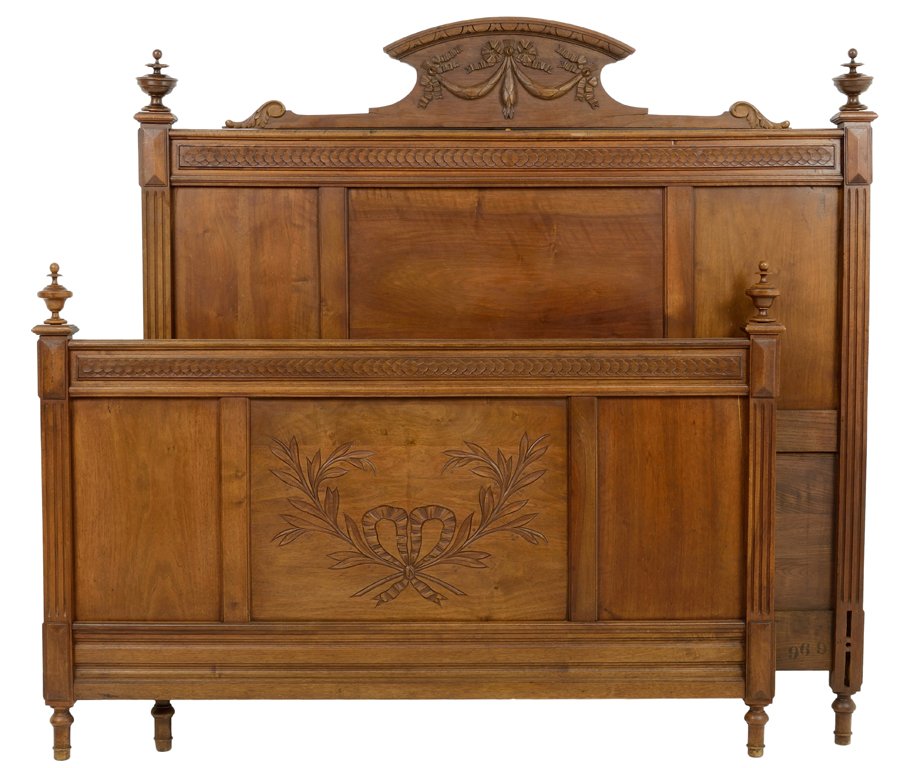 A FRENCH NEOCLASSICAL STYLE BED WITH BERRIBBONED AND: A FRENCH NEOCLASSICAL STYLE BED WITH BERRIBBONED AND LAUREL LEAF CREST Early 20th Century Minor wear and chipping detected. Some stress cracking detected. Overall in very good condition. Depth: 52½ i