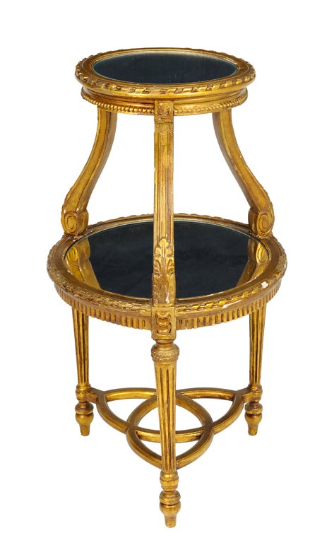 ANTIQUE FRENCH GILT WOOD TIER TABLE: ANTIQUE FRENCH GILT WOOD TIER TABLE The 19th Century tier table in the Louis XVI style having a carving and gilt finish features two round shelves graduated in size with mirror inserts, carved ribbon 