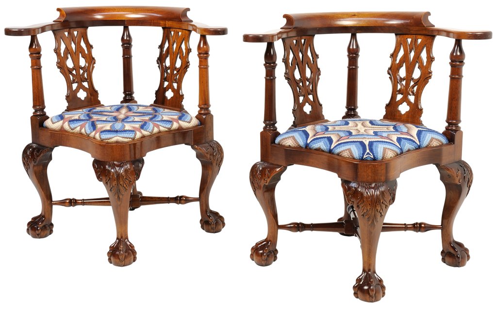 A PAIR OF CHIPPENDALE STYLE CORNER CHAIRS: A PAIR OF CHIPPENDALE STYLE CORNER CHAIRS 20th Century solid mahogany corner chairs with slip seats, ball and claw cabriole legs robustly carved with acanthus at the knee and turned ""X"" style stretc