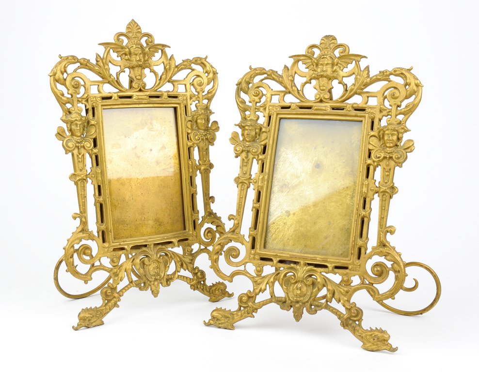 A PAIR OF GILT BRASS ART NOUVEAU STYLE PICTURE FRAMES: A PAIR OF GILT BRASS ART NOUVEAU STYLE PICTURE FRAMES WITH WINGED GARGOYLE, FAERIE AND DOLPHIN THEME Early 20th Century A pair of gilt-brass art nouveau style picture frames. Wear to gilt commensurate