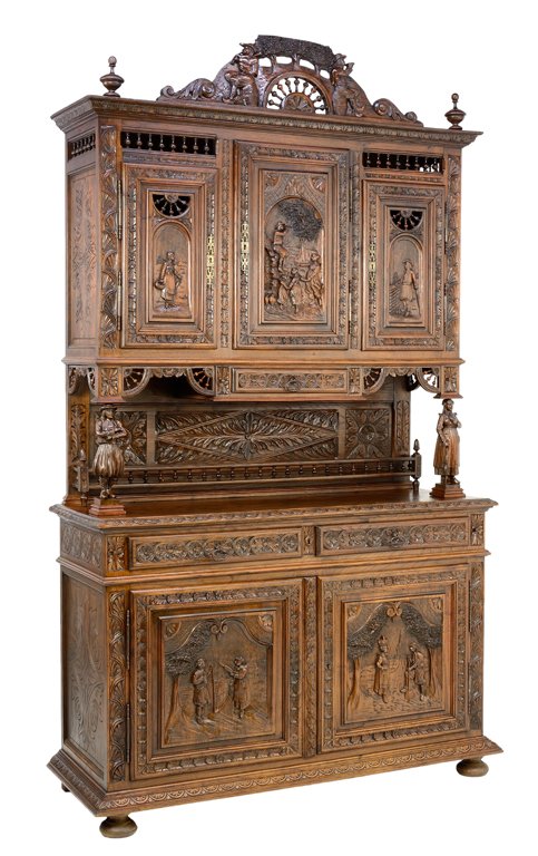 A FRENCH BRITTANY BUFFET WITH CARYATID FIGURES AND: A FRENCH BRITTANY BUFFET WITH CARYATID FIGURES AND PASTORAL SCENES Late 19th - Early 20th Century A heavily carved French Brittany style buffet with finial fan details, having pastoral scenes, feature