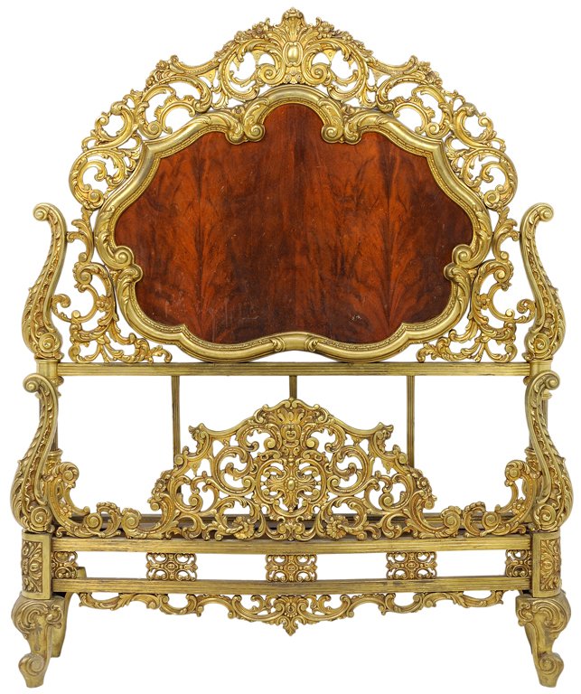 A ROCOCO REVIVAL STYLE GILT BRASS AND FLAME MAHOGANY: A ROCOCO REVIVAL STYLE GILT BRASS AND FLAME MAHOGANY BED circa Early 20th Century An ornately wrought brass and flame mahogany Rococo Revival style bed. Minor wear commensurate with age and use detect