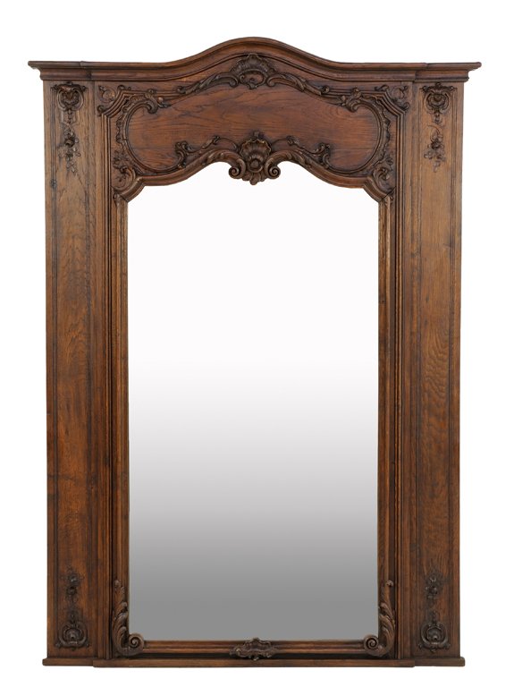 A FRENCH LOUIS XV STYLE OAK TRUMEAU MIRROR: A FRENCH LOUIS XV STYLE OAK TRUMEAU MIRROR The trumeau with arched cornice over shell and acanthus leaf carved decoration above vertical mirror plate. 71 x 51 x 2 inches.
