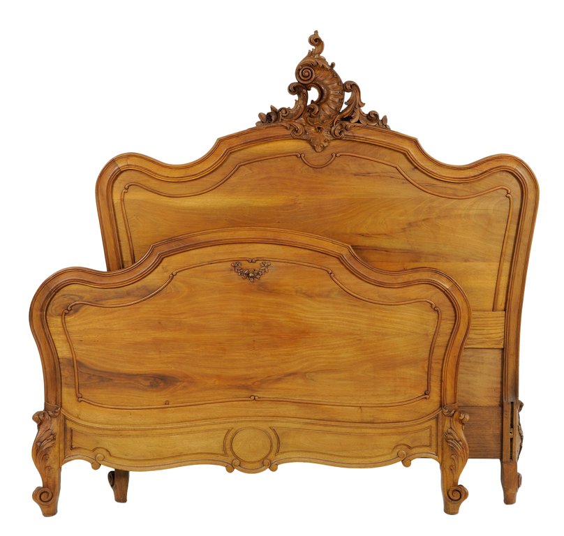 A FRENCH LOUIS XV STYLE WALNUT BED: A FRENCH LOUIS XV STYLE WALNUT BED The bed with carved rocaille and leaf decoration to top rail of headboard, raised on short cabriole legs. Comprising headboard, footboard and side rails. Width 51¾