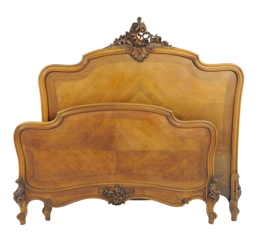 A FRENCH LOUIS XV STYLE WALNUT BED: A FRENCH LOUIS XV STYLE WALNUT BED The bed with carved rocaille and leaf decoration to top rail of headboard and apron of footboard, raised on short cabriole legs. Comprising headboard, footboard and