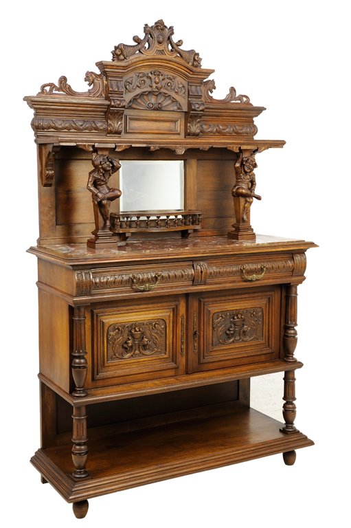A RENAISSANCE REVIVAL WALNUT SERVER: A RENAISSANCE REVIVAL WALNUT SERVER The pierce carved crest over the stepped cornice raised on figural supports, above the rectangular marble inset surface over two short drawers and two paneled doors
