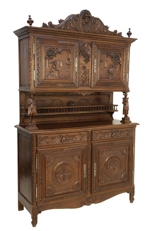 A RENAISSANCE REVIVAL WALNUT BUFFET A DEUX CORPS: A RENAISSANCE REVIVAL WALNUT BUFFET A DEUX CORPS The two tiered cabinet with two paneled doors with carved figural decoration below mask and foliate carved crest flanked by urn form finials, raised on