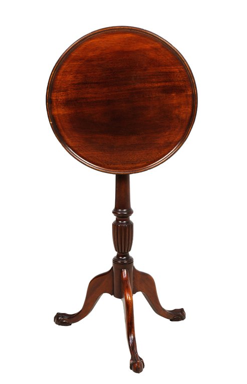 A CHIPPENDALE STYLE MAHOGANY TILT-TOP TEA TABLE: A CHIPPENDALE STYLE MAHOGANY TILT-TOP TEA TABLE Having a circular top over the baluster form standard, raised on a tripartite base ending in claw and ball feet. 27½ x 15½ x 15½ inches.