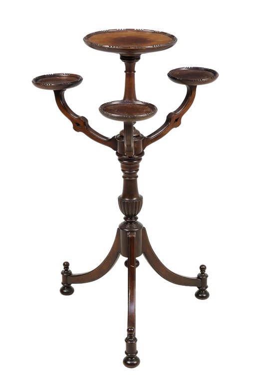 A VICTORIAN MAHOGANY JARDINIERE STAND: A VICTORIAN MAHOGANY JARDINIERE STAND The stand having four dish form surfaces, each raised on a shaped arm above the repeating baluster form standard, raised on a tripod base ending in flattened ball