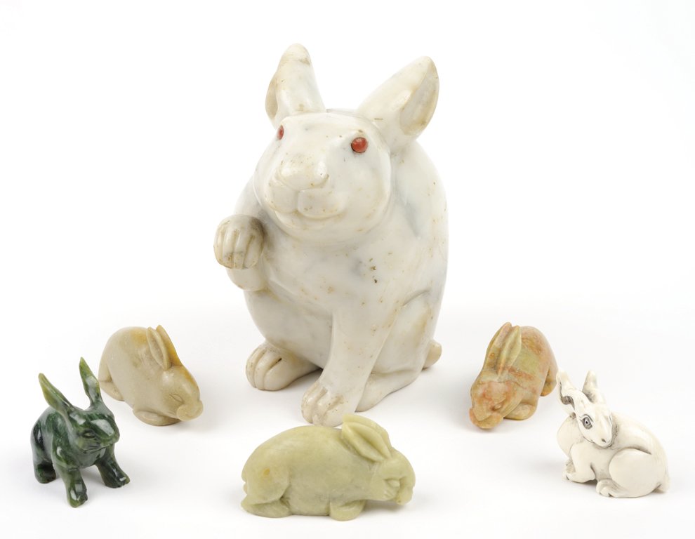 A GROUP OF CHINESE AND JAPANESE CARVED RABBIT FIGURES 6: A GROUP OF CHINESE AND JAPANESE CARVED RABBIT FIGURES The group comprised of a heavily veined marble figure with raised paw and inset carnelian eyes, an ivory netsuke, a green jade figure, and three o