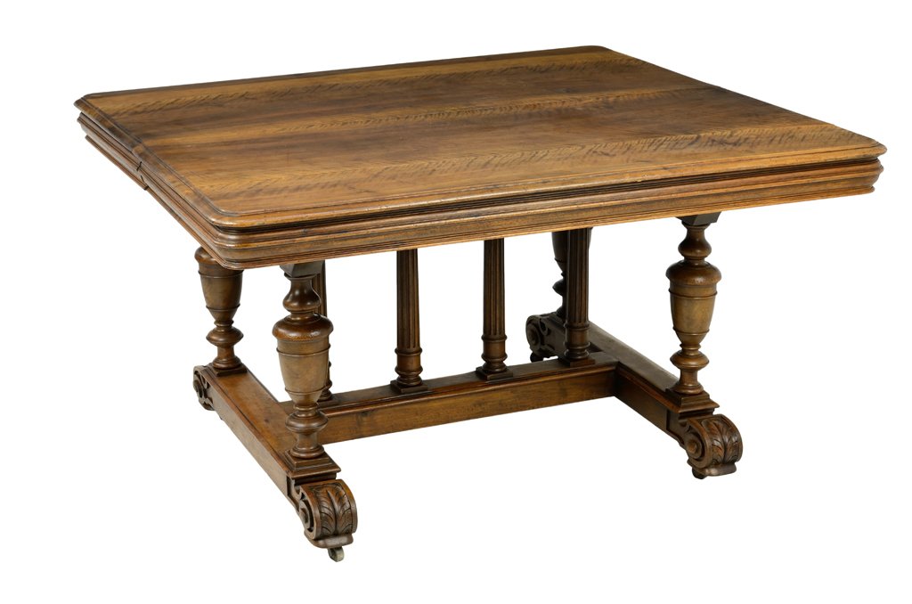 A FRENCH RENAISSANCE REVIVAL WALNUT DINING TABLE: A FRENCH RENAISSANCE REVIVAL WALNUT DINING TABLE The rectangular top with rounded corners over the conforming freize, raised on baluster form legs, joined by an H-form stretcher, ending in scrolled fe