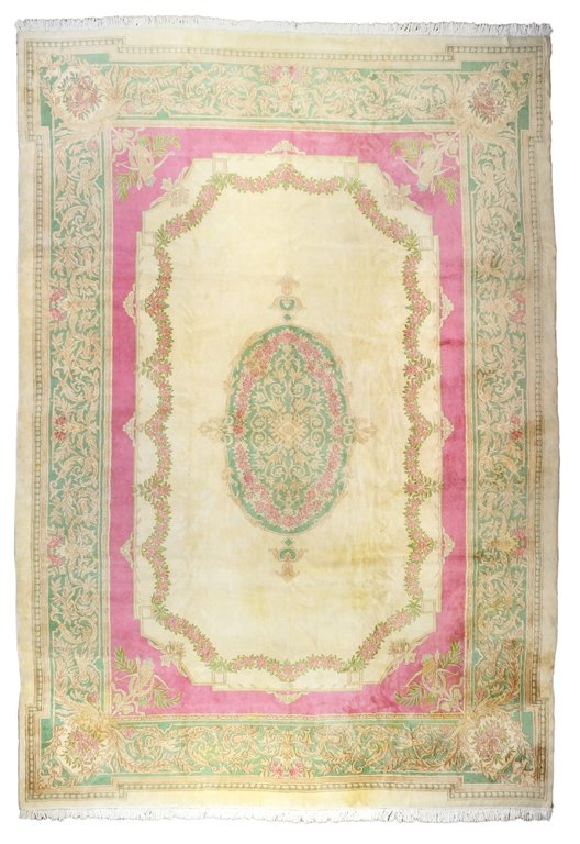 A HAND WOVEN PERSIAN KERMAN CARPET WITH FRENCH AUBUSSON: A HAND WOVEN PERSIAN KERMAN CARPET WITH FRENCH AUBUSSON DESIGN Iran, 20th Century French Aubusson design. Beige background. Light green border. Fine wool pile on cotton foundation. 17ft 9in X 11ft 10i