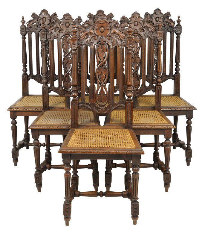 A SET OF SIX RENAISSANCE REVIVAL SIDE CHAIRS: A SET OF SIX RENAISSANCE REVIVAL SIDE CHAIRS Each having a shield form crest over the vertical and pierce carved back splats, flanked by reeded columns, above the caned trapezoidal seat, raised on tur