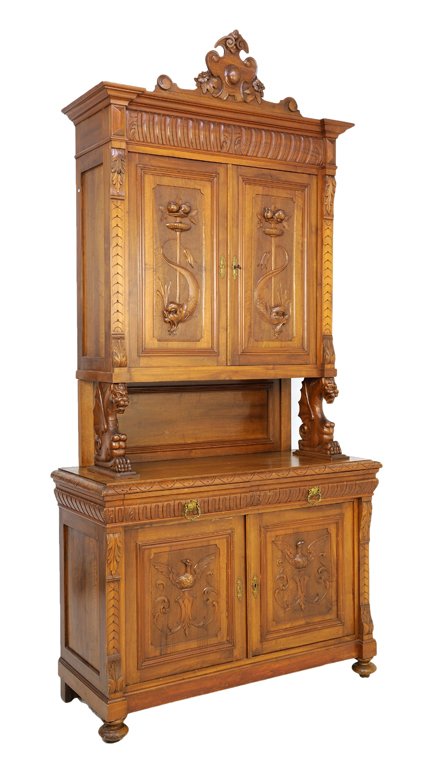 A CONTINENTAL RENAISSANCE REVIVAL WALNUT BUFFET A DEUX: A CONTINENTAL RENAISSANCE REVIVAL WALNUT BUFFET A DEUX CORPS 20th Century The cabinet fitted with two upper paneled doors with carved dolphin and fruit decoration, surmounted with a flared pediment an