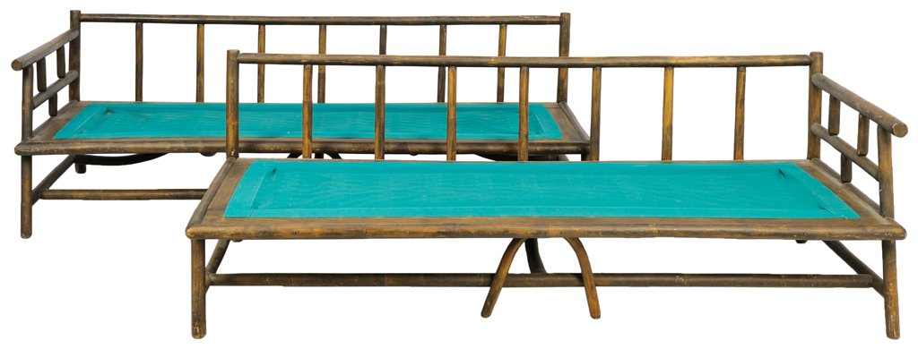 A PAIR OF RUSTIC CHINESE LUOHAN BEDS: A PAIR OF RUSTIC CHINESE LUOHAN BEDS Each bed having a straight back rail over a series of vertical back splats, above the canvas inset base, raised on cylindrical legs, joined by stretchers. 26 x 75�