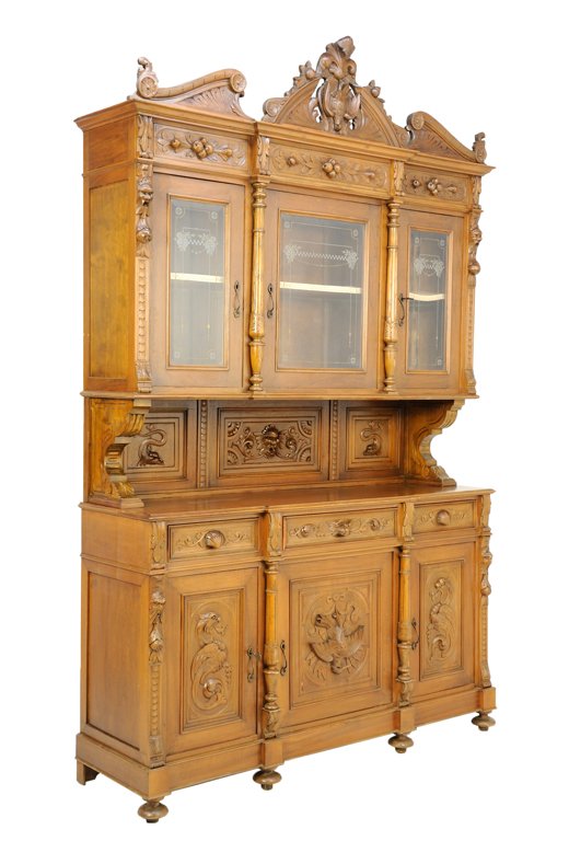 A RENAISSANCE REVIVAL WALNUT BUFFET A DEUX CORPS: A RENAISSANCE REVIVAL WALNUT BUFFET A DEUX CORPS The cabinet with broken pediment crest with carved fowl and foliate decoration, carved fruit freize above three glazed etched cabinets, the lower secti