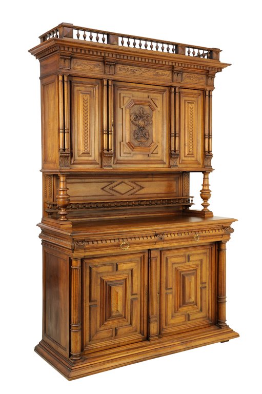 A RENAISSANCE REVIVAL WALNUT BUFFET A DEUX CORPS: A RENAISSANCE REVIVAL WALNUT BUFFET A DEUX CORPS The buffet having a galleried pediment over a flared and dentiled cornice above three paneled doors flanked by pairs of columns, raised on baluster for