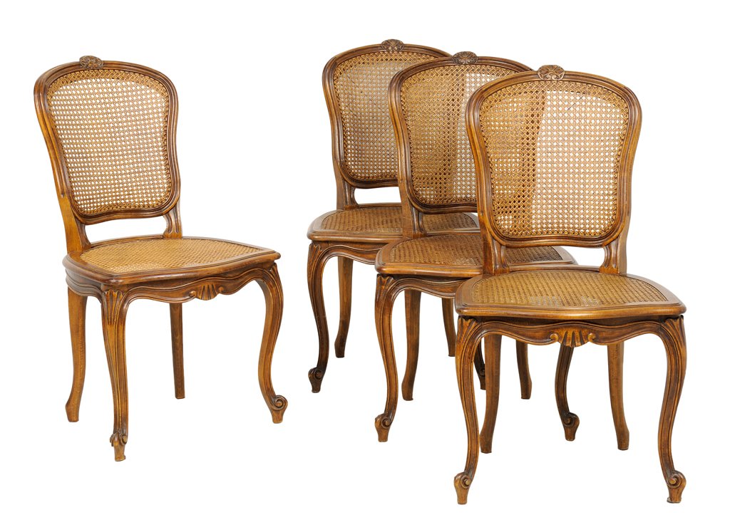 A SET OF FOUR FRENCH LOUIS XV STYLE SIDE CHAIRS: A SET OF FOUR FRENCH LOUIS XV STYLE SIDE CHAIRS Each chair having a curved crest rail centered with a shell over the caned back and seat, above the shaped apron, raised on cabriole legs ending in scro