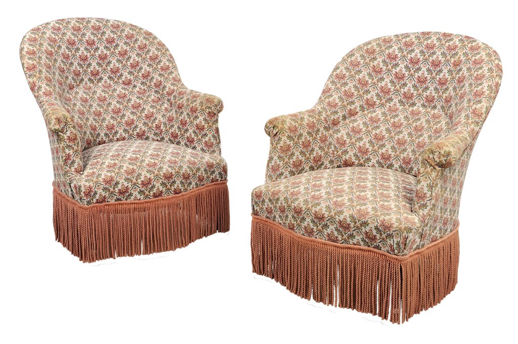 A PAIR OF VICTORIAN STYLE SLIPPER CHAIRS: A PAIR OF VICTORIAN STYLE SLIPPER CHAIRS Each chair having an upholstered back, arms and seat above a fringed skirt, set on casters. 33½ x 29 x 30½ inches.