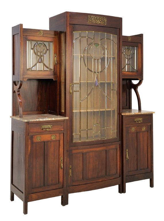 AN ARTS AND CRAFTS STYLE SIDEBOARD: AN ARTS AND CRAFTS STYLE SIDEBOARD The sideboard having a straight crest rail over a single glazed door with stained glass inlay, flanked by two upper cabinets with glazed doors, raised on shaped supp