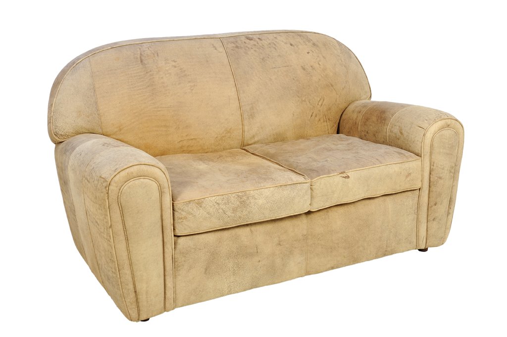 A NORWALK DISTRESSED LEATHER SOFA: A NORWALK DISTRESSED LEATHER SOFA Having a curved back over the upholstered seat and arms, with label to base. 35¼ x 62 x 36½ inches.