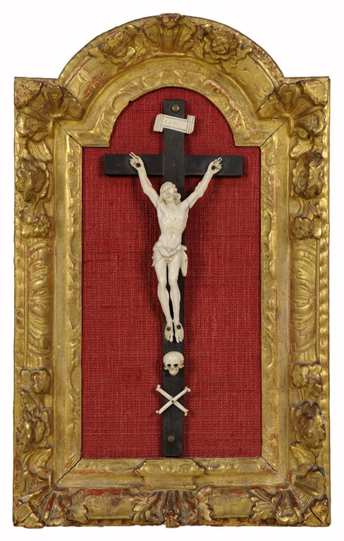 A FRENCH CARVED IVORY AND GILTWOOD CRUCIFIX: A FRENCH CARVED IVORY AND GILTWOOD CRUCIFIX Depicting the crucifixion of the Christ, the carved ivory corpus bordered above by a placard reading "INRI" and below by a skull and cross-bones, each being